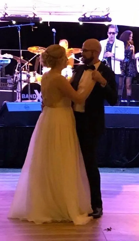 Bride and groom dancing in front of the stage