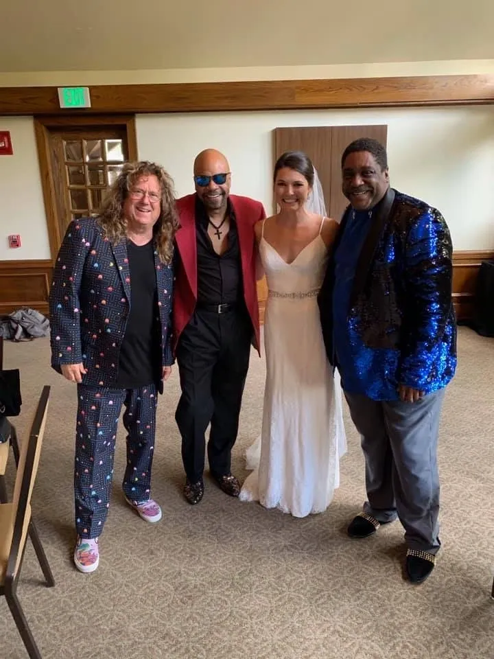 Four men posing for a photo with the bride