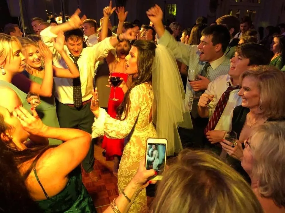Group of people dancing around the bride